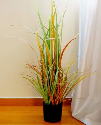 An artificial plant of green-orange leaves in pot to decorate your space, for indoors.