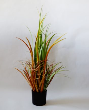 An artificial plant of green-orange leaves in pot to decorate your space, for indoors.