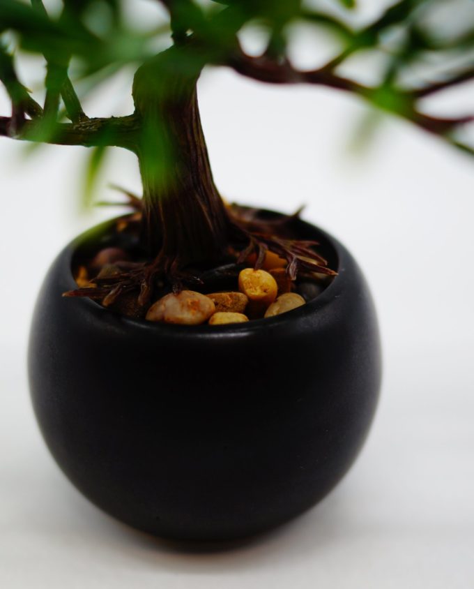 An artificial Bonsai tree in ceramic pot with pebbles to decorate your space, for indoors.