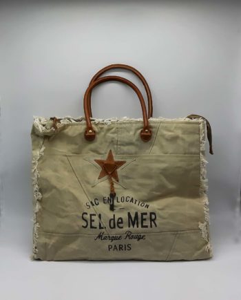 A convenient big cotton beach bag with long leather handles in order to be able to carry fuss free everything you need.