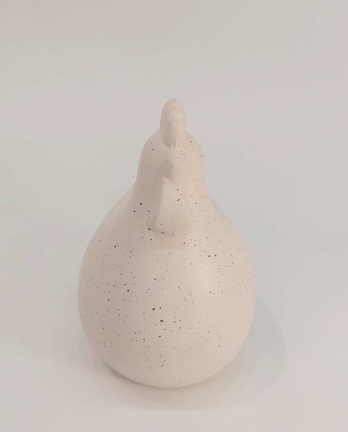 A ceramic cute round chicken with spots