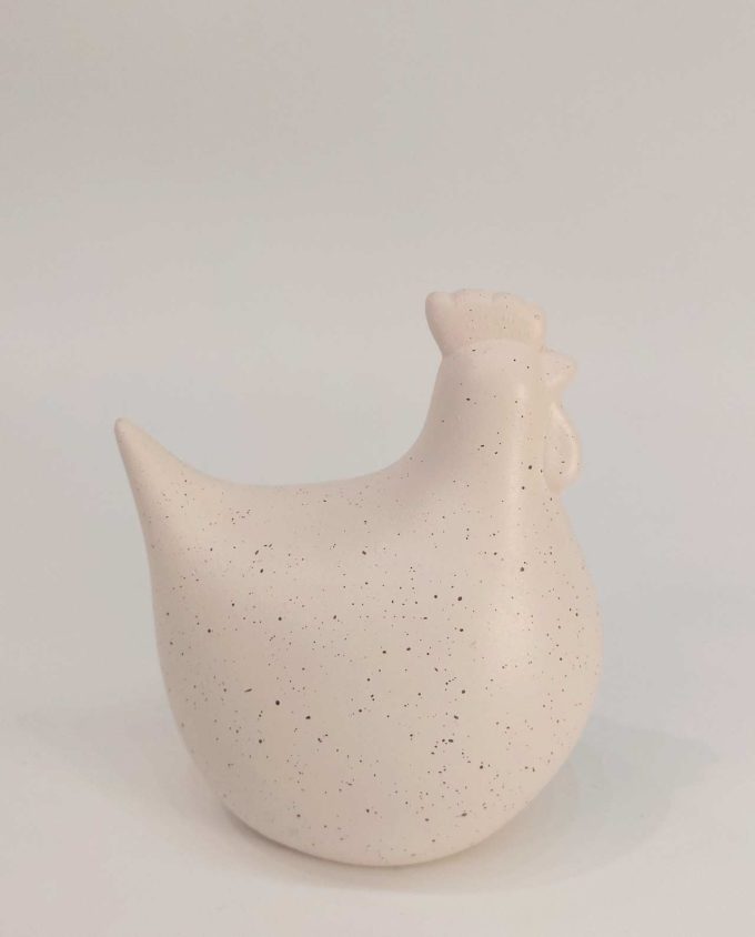 A ceramic cute round chicken with spots