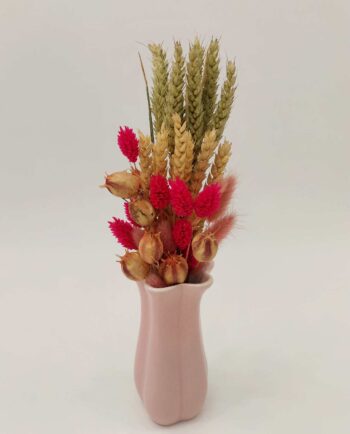 dried flower arrangement in pink ceramic vase